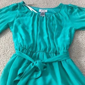 Teal mini dress that has open sleeves and ties